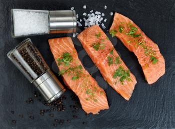 Preparing raw wild salmon steaks for meal time 