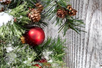 Close up of a Christmas red ball ornament on rustic wood 