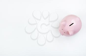 Piggy Bank on white desktop with copy space