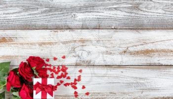 Romantic Valentines Day celebration with gifts in lower left corner of white rustic wood 