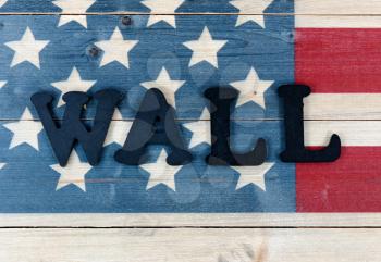 Vintage wooden United States flag with metal letters spelling wall for national security border concept