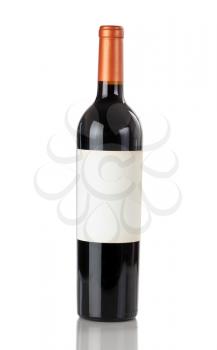 Unopen bottle of red wine isolated on a white background with reflection in close up view 