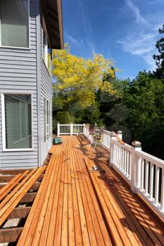 Outdoor wooden deck being completely remodeled during springtime season  