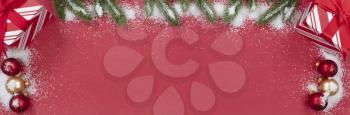 Christmas decorations on red background with snow  