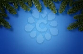 Merry Christmas holiday top circle fir branch border on blue background for the seasonal tradition   