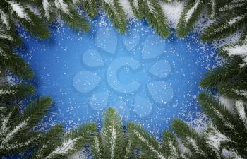 Merry Christmas holiday full circle snowy fir branch border on blue background for the seasonal tradition   