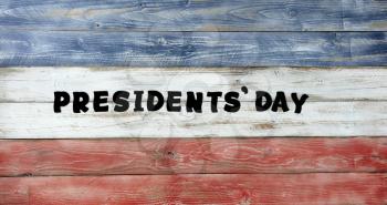 Presidents day in large text letters on rustic painted wooden boards with USA traditional colors 