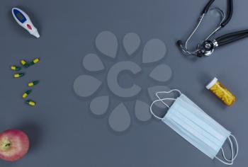 Medical equipment on gray table for health care concept in flat lay setup with copy space available 