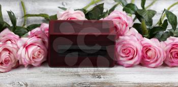 Close up of a cremation funeral box with rose flowers for death concept from Coronavirus or COVID-19