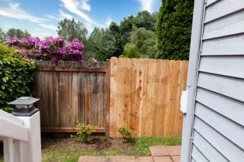Side by side comparisons of new and old wooden cedar fence 