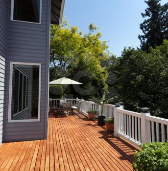 Outdoor home wooden deck patio during lovely summer day with seasonal garden 
