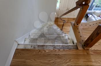 Renovation of home staircase with exposed plywood and new red oak wooden floor boards