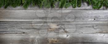 Merry Christmas and Happy New Year fir branches on rustic wooden boards 
