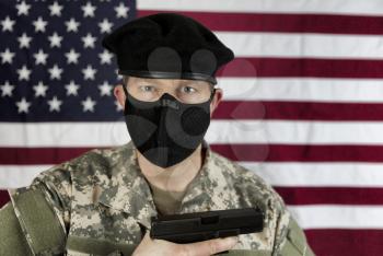 Armed male US soldier wearing facemask for coronavirus pandemic protection. 