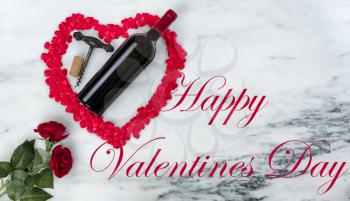 Happy Valentines Day with lovely red outline shape of large heart and romantic gifts including wine on natural marble stone background plus text message