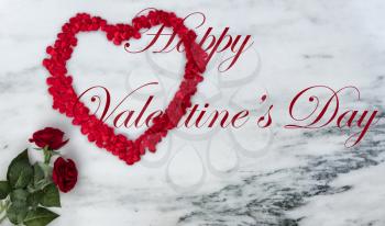 Happy Valentines Day with lovely red rose flowers plus outline shape of large heart on natural marble stone background including text message