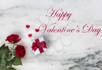 Happy Valentines Day with lovely red rose flowers plus giftbox on natural marble stone background including text message