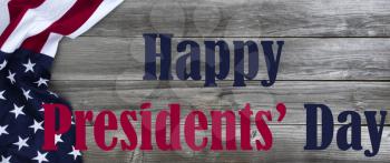 Happy Presidents Day text message with draped US flag on left side of natural rustic wood