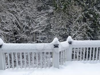 Winter time with fresh snow on home outdoor deck 