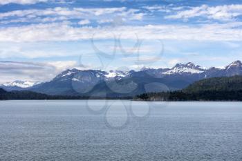 Snowcapped mountain range in Alaska with waterfront 