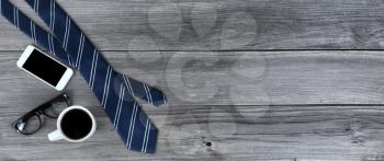 Blue striped necktie plus coffee on aged wooden desk for Happy Fathers Day concept at work