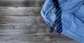 Blue shirt and necktie on vintage wooden planks for Fathers Day Concept 