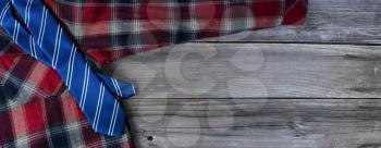Plaid shirt and blue necktie on vintage wooden planks for Fathers Day Concept 