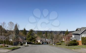Lovely spring day view of a residential neighborhood community in Washington State USA, with view of cascade mountains in background