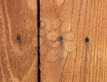 Metal screws starting to rust in outdoor wooden cedar fence  