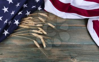 Waving American flag and dry wheat stalks for Memorial Day, Labor Day and 4th of July peace holiday concepts 