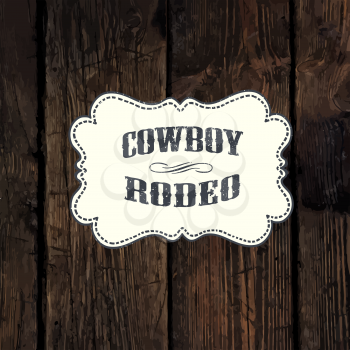 Western styled label on aged wooden wall background