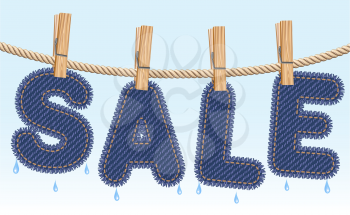 Blue jeans SALE word drying on a clothesline