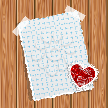 Blank notebook paper and small valentine on a wooden wall