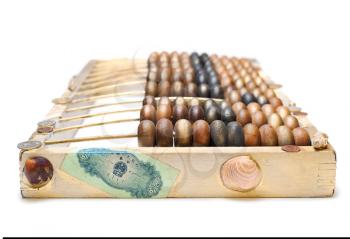 abstract composition from the old wooden abacus, coins and shells isolated on white background, selectiv focus