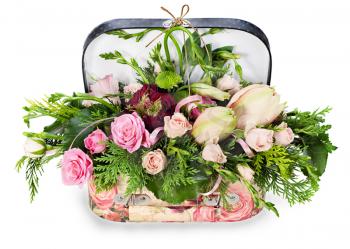 a colorful floral arrangement of roses and lilies in acardboard chest, isolated on white background