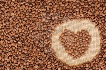heart coffee frame made of coffee beans on burlap texture