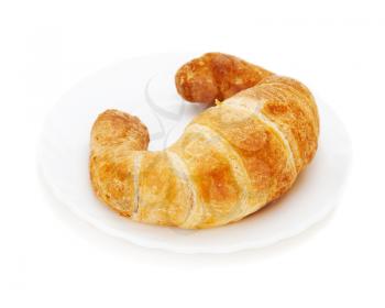 fresh and tasty croissant on plate isolated on white background