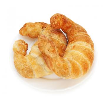 fresh and tasty croissant on plate isolated on white background