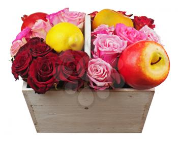 Flower arrangement of red roses and fruits in wooden basket isolated on white background. Closeup.