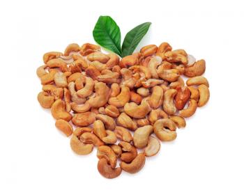 Cashew nuts in the form of heart with leaves isolated on white background