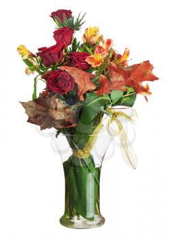 Floral bouquet of roses and lilies arrangement centerpiece in glass vase isolated on white background. Closeup.
