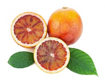 Blood oranges with cut and green leaves isolated on white background. Closeup.