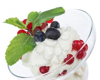Ice cream in glass bowl with fruits isolated on white background. Closeup.