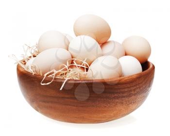 Eggs in wooden bowl isolated on white background.
