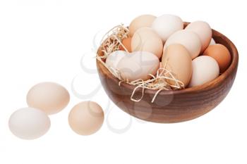 Eggs in wooden bowl isolated on white background.
