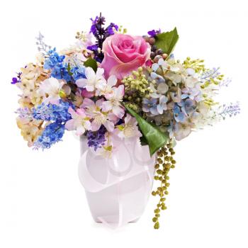 Bouquet from artificial flowers arrangement centerpiece in vase isolated on white background. Closeup.