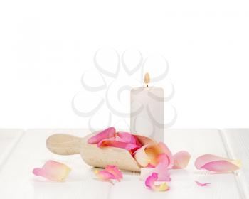 Rose petals on white wooden plates. Closeup.