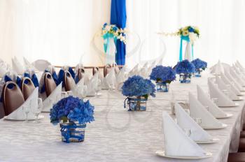 Hydrangea Flowers in Glass Vases on Festive Table with Cutlery.