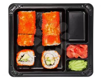 Japanese cuisine California maki sushi with masago in black plastic container for carrying food isolated on white background. Roll made of crab meat, avocado, cucumber inside and masago (smelt roe) ou