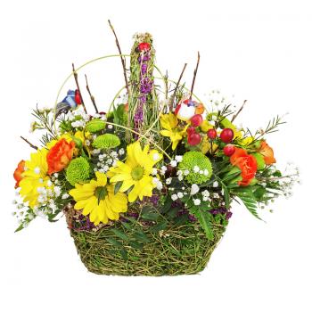 Flowers bouquet arrangement centerpiece in wicker basket isolated on white background.